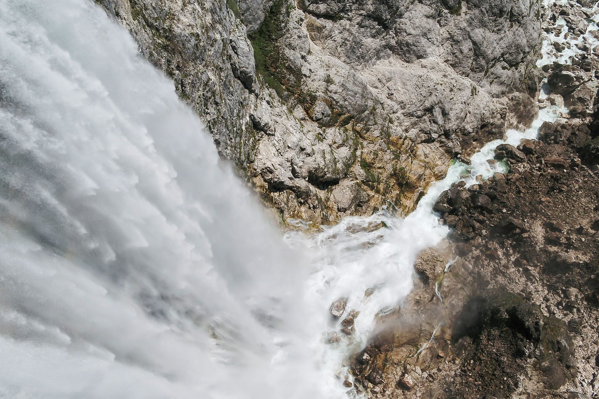 Fly fisherman casting into the turquoise Soča river at dawn